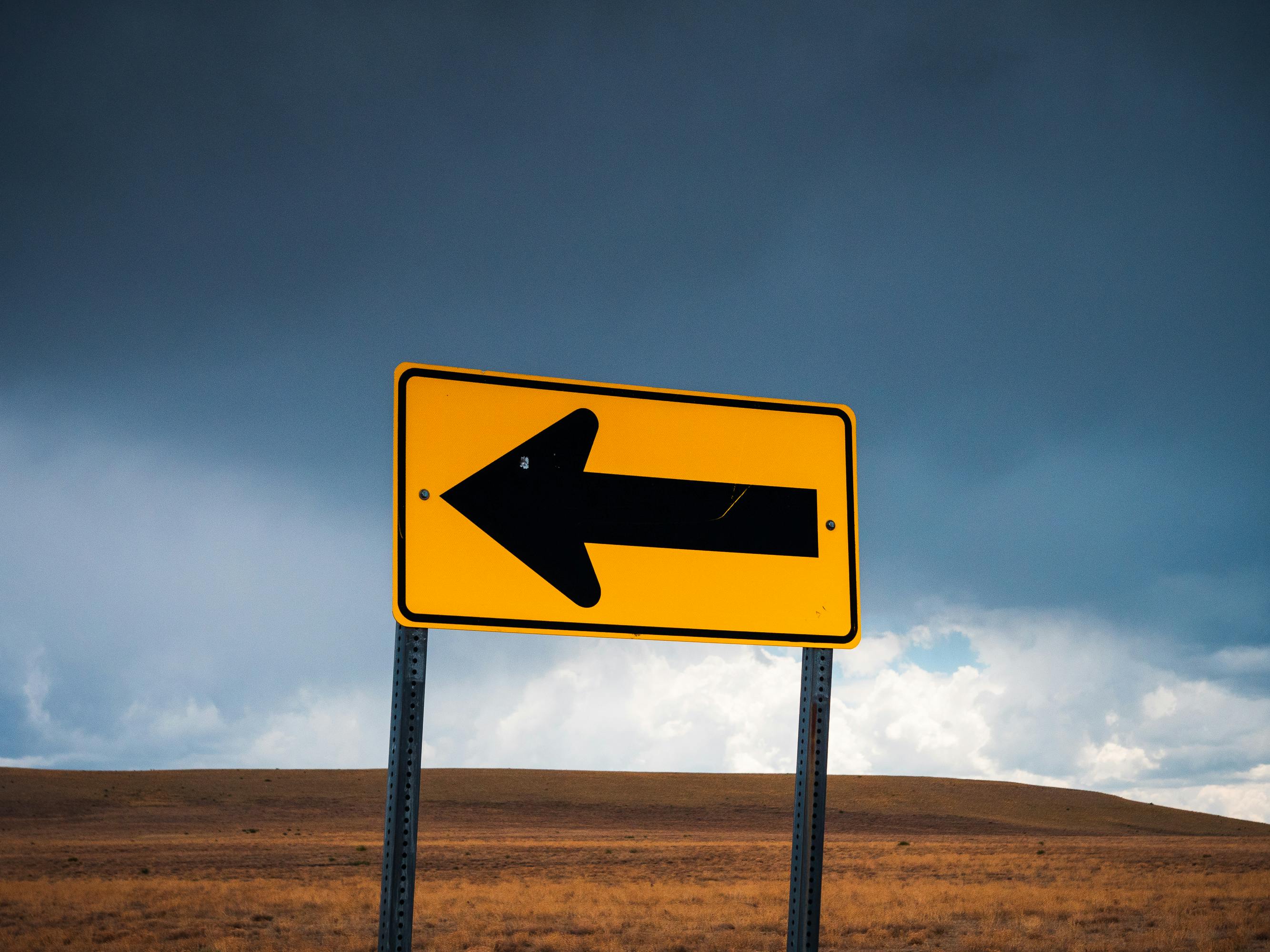Road sign with an arrow, representing URL redirects and SEO migration paths